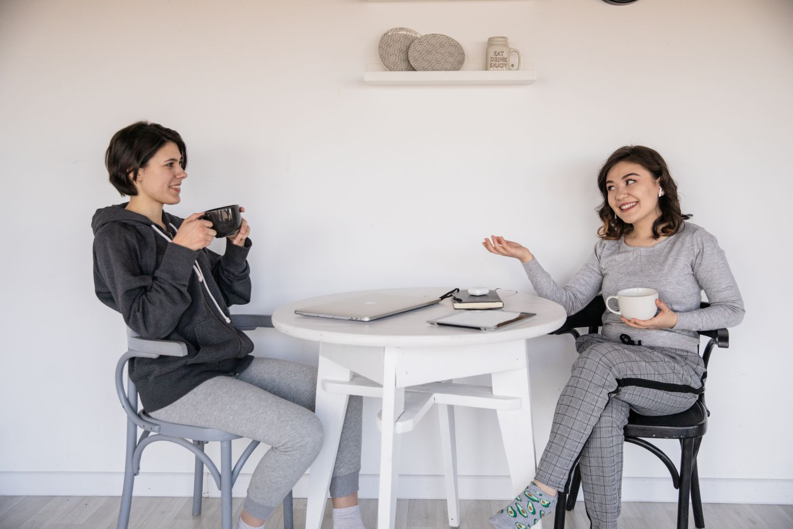 Two women having a conversation over coffee, the kind of talk an ADHD brain loses by Thursday